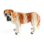 A 19thC Staffordshire style figure, of a standing St Bernard with gilt collar, 24cm high.