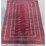 A Persian rug, of rectangular form, with an inner panel of geometric shapes, with an outer field dec