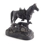 After Dubucand. A 20thC spelter figure group of horse and two greyhounds, on an oval naturalistic ba