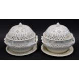 A pair of late 20thC creamware tureens, each with domed lids, acorn knops, entwined handles and circ