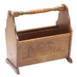 A carved oak two section magazine rack, with turned handle, 44cm wide.