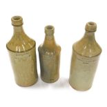 A 19thC stoneware porter bottle, impressed S Dobson Wine and Spirit Merchant Brigg, 26cm high, anoth