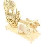 A late 19thC Indian carved ivory group, modelled with a cart, pulled by two cows, 10cm long.