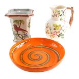 A retro Portuguese studio pottery bowl, in orange with brown and white swirl pattern, 33cm diameter,