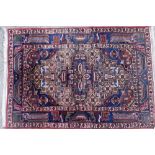 A Persian Kayam rug, with a central four sided shaped medallion, on a blue ground with pink and blue