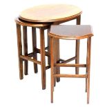 An oak nest of three tables, the largest with an oval top, the smallest of the same size, on taperin
