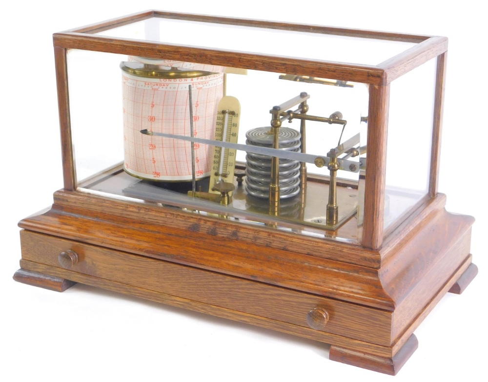 An oak cased and brass barograph, with fitted ivorine thermometer, in an oak case with drawer, 37cm