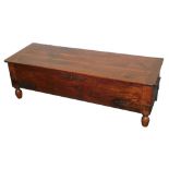 An unusual shallow oak coffer, the planked top with cleated ends, the base with pierced brass straps