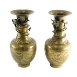 A pair of 20thC bronze Chinese vases, each with trumpet stems raised with entwined dragons each body