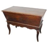 A late 18th oak dough bin, the rectangular top with a moulded edge, above a tapering base on associa