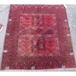 A Pakistani Turkoman rug, with a geometric design of latchhook medallions, etc., on a red ground wit