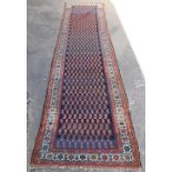 A Persian runner, the outer field with a geometric floral pattern in cream and red, the inner with s