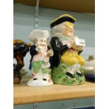 A Staffordshire pottery Toby jug and a smaller Toby jug. (2)