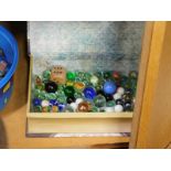 A modern book box, containing a quantity of marbles.