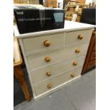 A painted pine chest of two short and three long drawers, on a plinth.