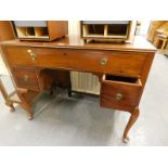 A mahogany dressing table with three drawers on cabriole legs.
