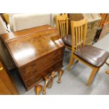 A walnut and burr walnut bureau, (AF) and two dining chairs.