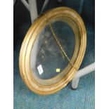 A giltwood classical frame, of oval form, with bead outline, and a further line border, broken by wh