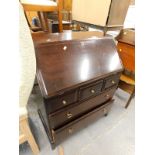 A Stag mahogany bureau with an arrangement of three short and two long drawers.