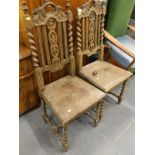 A pair of Victorian carved oak side chairs, each with a solid seat. (AF)