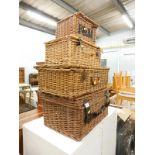 A collection of four wicker picnic hampers.