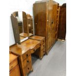 A walnut Art Deco triple wardrobe on short cabriole legs and a matching dressing table.