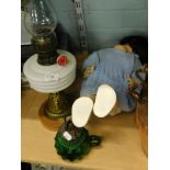 A Victorian and later oil lamp, an early plastic doll and a small handheld green glass oil lamp.