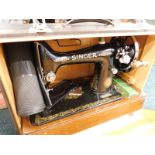 A Singer sewing machine, in simulated crocodile skin printed case.