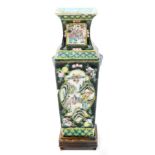 A 19thC Chinese famille noire square section tapering vase, with cartouches of figures in landscapes