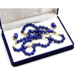 A lapis lazuli necklace and earring set, the necklace with lapis and pearl brakes, with a 9ct gold w