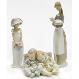 Three Lladro porcelain figures, comprising girl holding flower basket, 21cm high, girl holding lamb,