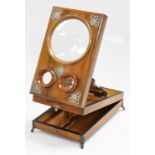 A Victorian olive wood and silver plated stereo viewer, with two circular eye holes and circular ape