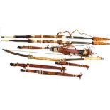 A group of Native American tribal weapons, comprising pair of spears, a bow, four short handled kniv