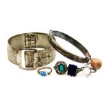 A group of costume jewellery, comprising a silver hinged bangle, three dress rings, each of Deco des
