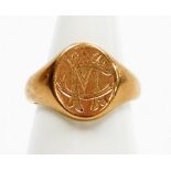 A 9ct rose gold signet ring, with oval shield bearing the initials CM, on a plain band, Birmingham 1