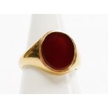 A 9ct gold gentleman's signet ring, with oval crest set with orange agate, London 1956, ring size O½