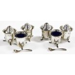 A George VI silver part cruet, comprising two salt pots, two pepper pots and two open salts with blu