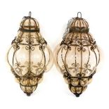 A pair of Continental wrought iron and lobed glass hanging lanterns, 40cm high.