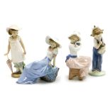 Four Nao porcelain figures, comprising girl with umbrella, 19cm high, girl reposing on rock, 15cm hi