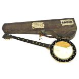 An early 20thC wooden cased banjo, cased, bearing paper labels for P&O Steam Ship Navigation Company