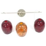 A three branch ceiling light, with crackled red and orange glass pendant shades, 72cm wide.