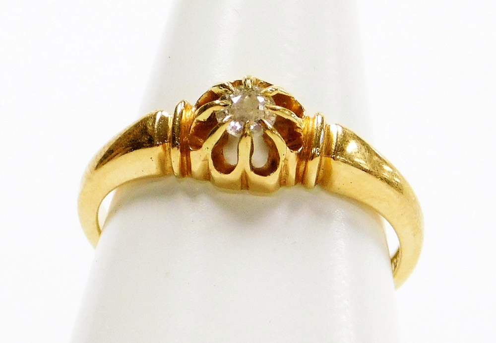 An 18ct gold diamond dress ring, the tiny diamond in cluster claw setting with etched design shoulde