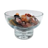 A cut glass bowl, containing polished hardstone pebbles, 17cm wide.