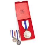 A Queen Elizabeth Silver Jubilee Medal 1977, and two miniature medals. (3)