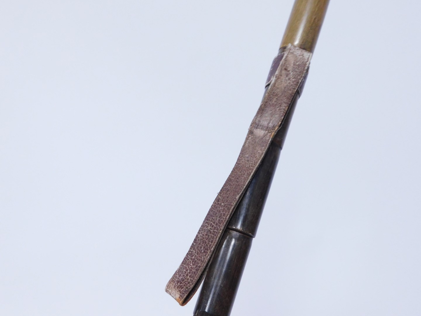 A horn walking stick, early 20thC, with leather strop, 81cm wide, together with a bamboo walking - Image 2 of 4