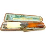 A Victorian amber cheroot holder, with silver mounts, amber cheroot and bakelite top with foliate