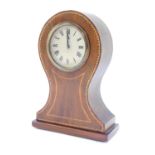 An Edwardian mahogany and line inlaid mantel clock, the circular dial bearing Roman numerals,