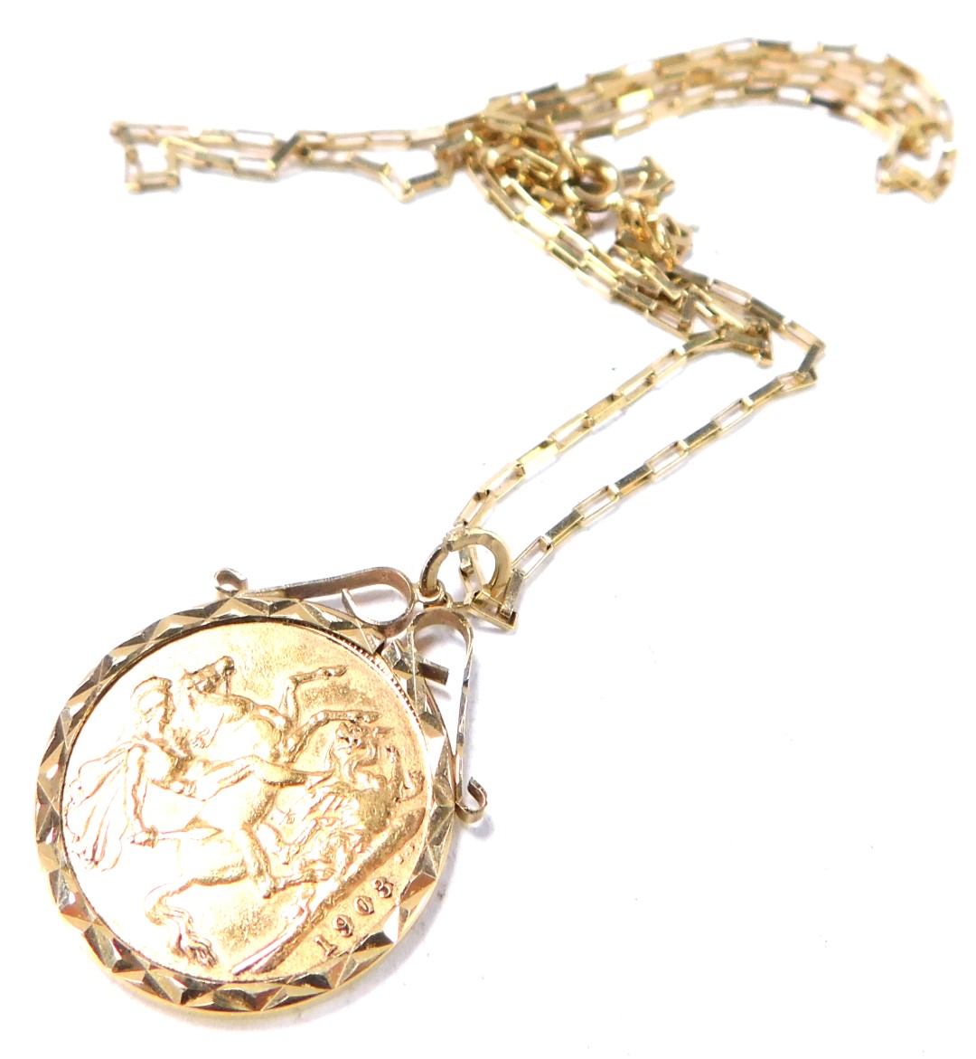An Edward VII full gold sovereign pendant and chain, dated 1903, in a 9ct gold frame, with 9ct