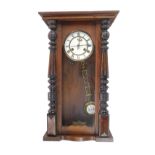 A 19thC Vienna walnut wall clock, the glazed door with white enamel dial and thirty hour movement,