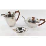 An EPNS three piece silver plated tea service, with brown handle and knop, ribbed border, maker S&W.